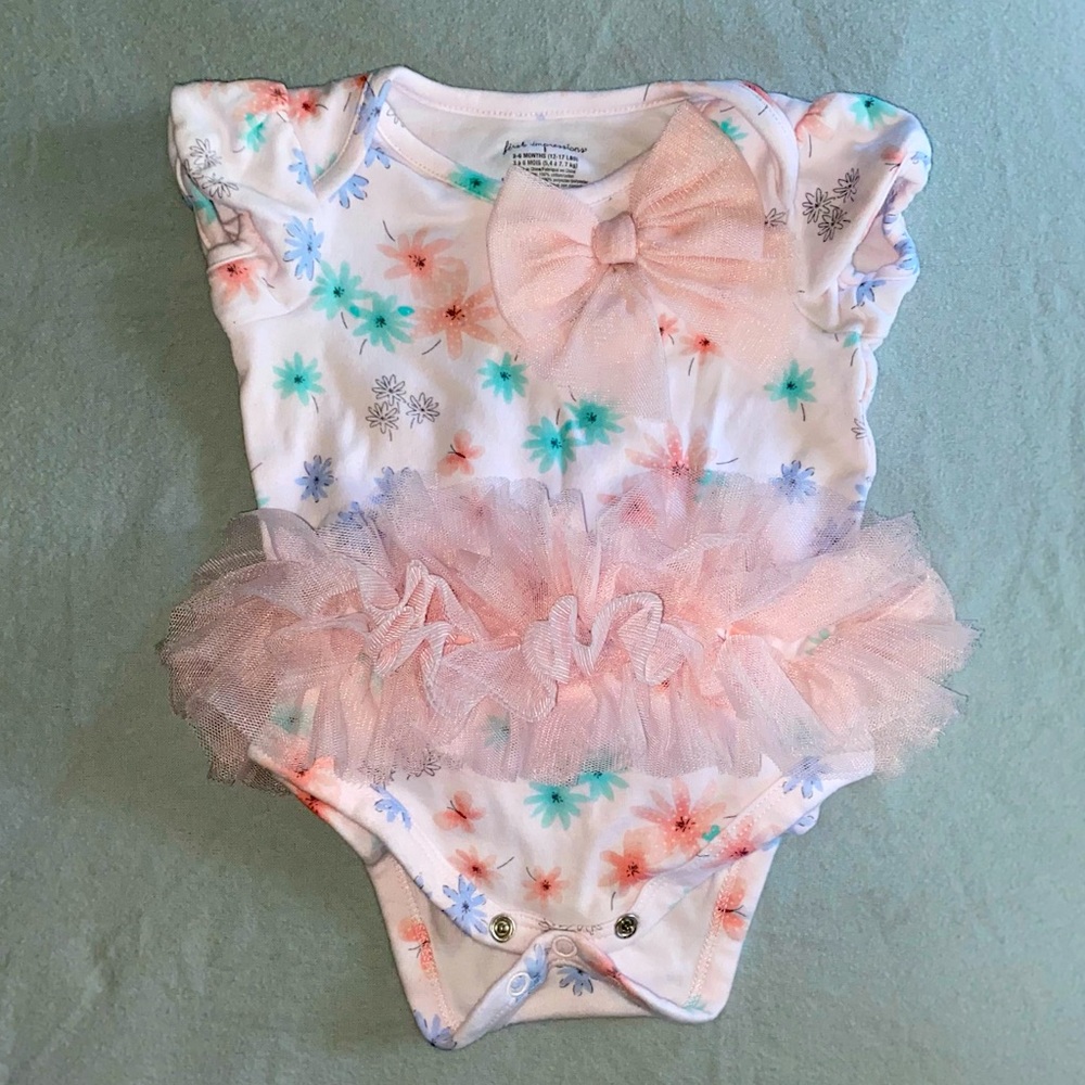 Pink flower print tutu one piece for a baby girl.